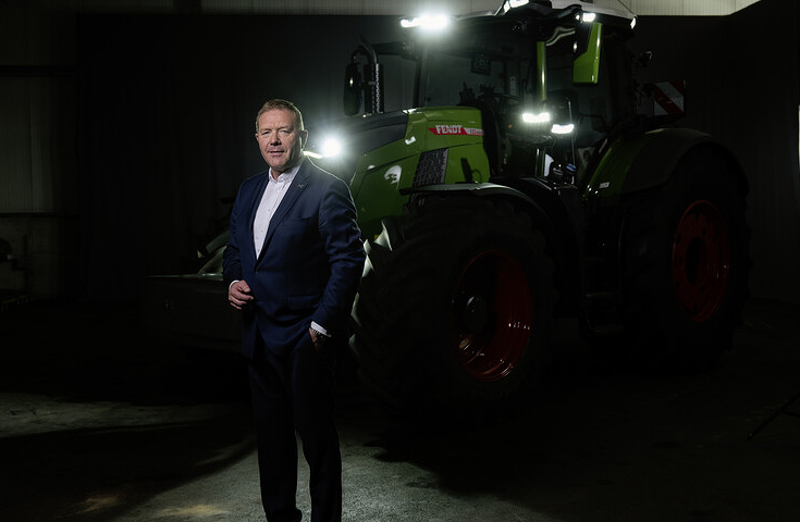 Fendt Chairman of the Board proudly stands in front of a Fendt Vario tractor