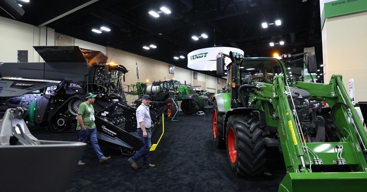 Farmers walk around the Fendt Booth  at Commodity Classic