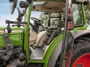 Cab with open door with view of the steering wheel and driver's seat