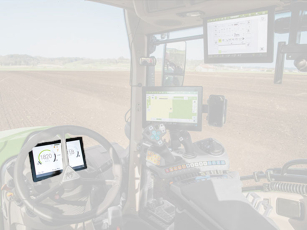 Interior view of a modern tractor cab with a 10-inch dashboard that displays both road-legal driving data and machine-related information.